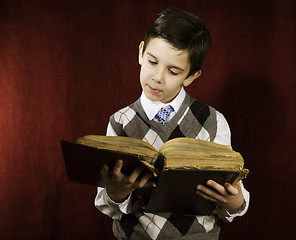 Image showing Child with red vintage book