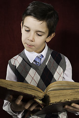 Image showing Child with red vintage book