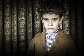 Image showing Frowning child in vintage clothes and hat