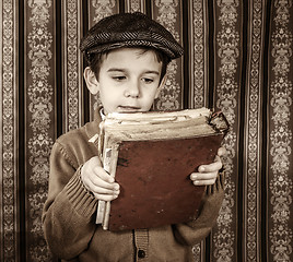 Image showing Child with red vintage book