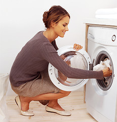 Image showing young housewife doing laundry