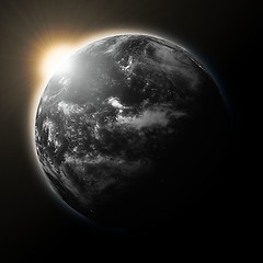 Image showing Sun over Pacific Ocean on dark planet Earth