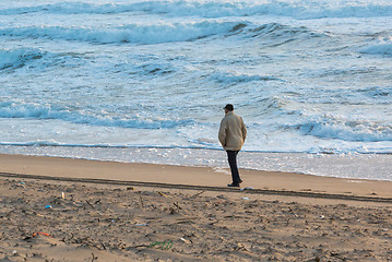 Image showing Man Walks Along Coast
