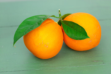 Image showing Two big Oranges with Leaves