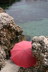 Image showing Red parasol by the sea