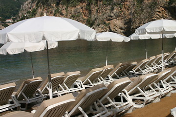 Image showing Beach chairs and parasols