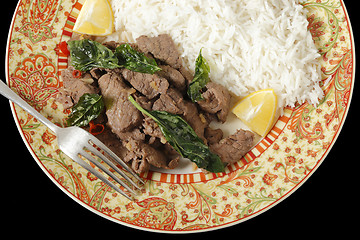 Image showing Chilli beef with basil over black