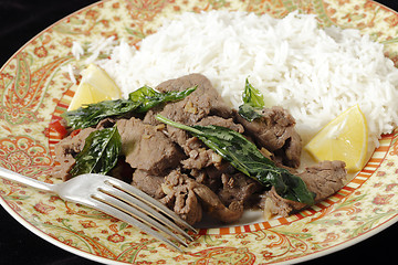 Image showing Chilli beef plate with basil leaf garnish