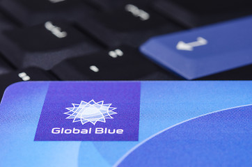 Image showing Global Blue closeup logo on plastic card against black ThinkPad 