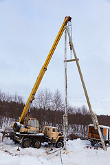 Image showing Construction of power lines using a mobile crane 