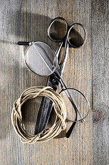 Image showing old scissors, glasses and hank of packthread on wooden backgroun