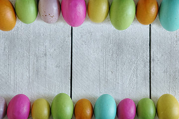 Image showing Easter or Spring Themed Background of Old Wood and Colored Eggs 