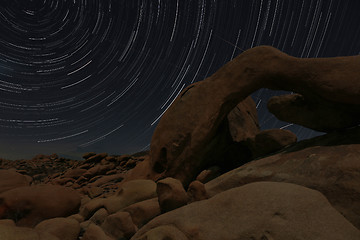 Image showing Night Star Trail Streaks over the Rocks of Joshua Tree Park