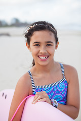 Image showing Happy young girl with surfboard