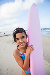 Image showing Happy young girl with surfboard