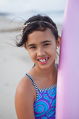 Image showing Happy young girl with surfboard