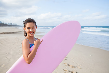 Image showing Happy young girl with surfboard