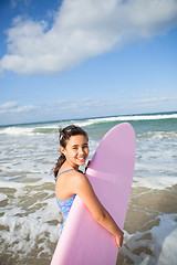 Image showing Happy young girl with surfboard