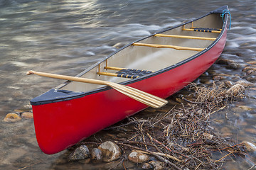 Image showing red canoe with a paddle