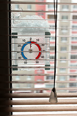 Image showing thermometer with layer of snow showing two degrees