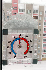 Image showing thermometer with layer of snow showing two degrees