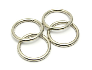 Image showing Four rings of metal arranged