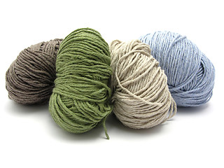 Image showing Four lying balls of wool