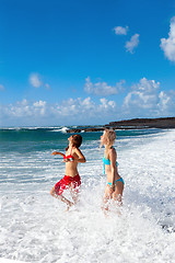 Image showing happy girls on the beach with black sand 