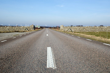 Image showing Low perspective at road with windmills ahead