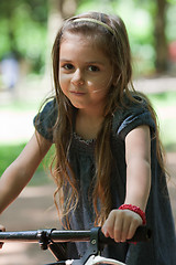 Image showing Little girl riding bicycle