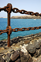 Image showing rusty chain  water  boat  and sr in lanzarote spain