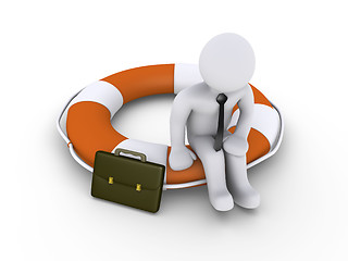 Image showing Businessman sitting on lifebuoy