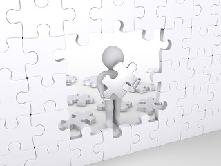 Image showing Person holding puzzle piece about to complete vertical puzzle