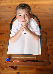 Image showing Child at desk with open book
