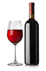 Image showing Glass and black bottle of red wine