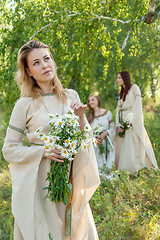 Image showing Beautiful woman with bouquet of camomiles