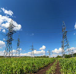 Image showing electric masts and road in green field