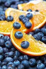 Image showing Freshly picked blueberries with orange