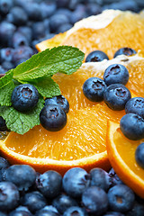 Image showing Freshly picked blueberries with orange