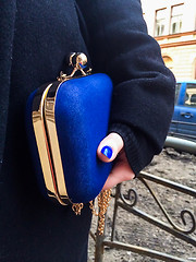 Image showing Woman holding a blue handbag in her hand