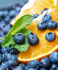 Image showing Freshly picked blueberries with orange