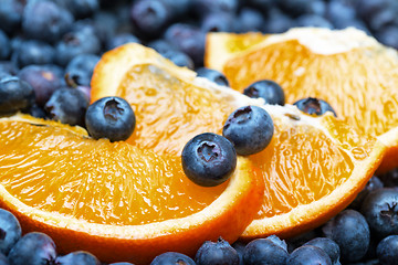 Image showing Freshly picked blueberries with orange