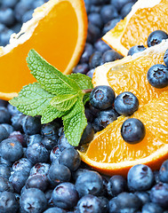 Image showing Freshly picked blueberries with orange