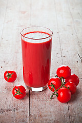 Image showing tomato juice in glass and fresh tomatoes 