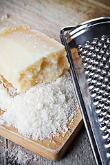 Image showing grated parmesan cheese and metal grater