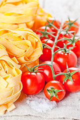 Image showing uncooked pasta and fresh tomatoes 