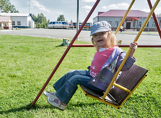 Image showing Smiling girl on swing