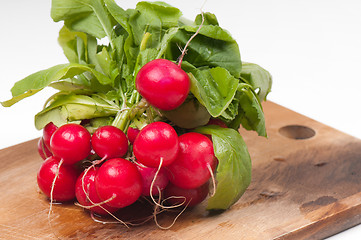 Image showing Fresh radishes on old wooden board