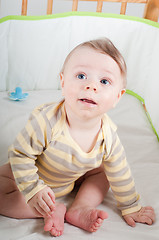 Image showing Baby boy in cradle looking up