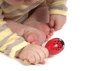 Image showing Baby hand with red toy